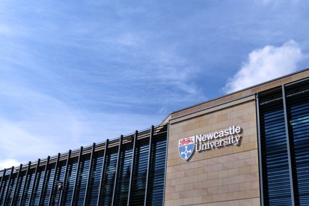  Newcastle University Kings Gate building, with university logo and lettering against sandstone wall